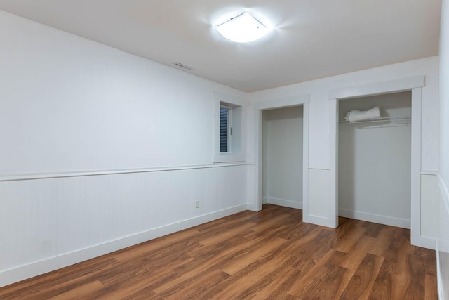 unfurnished bedroom featuring dark wood-type flooring