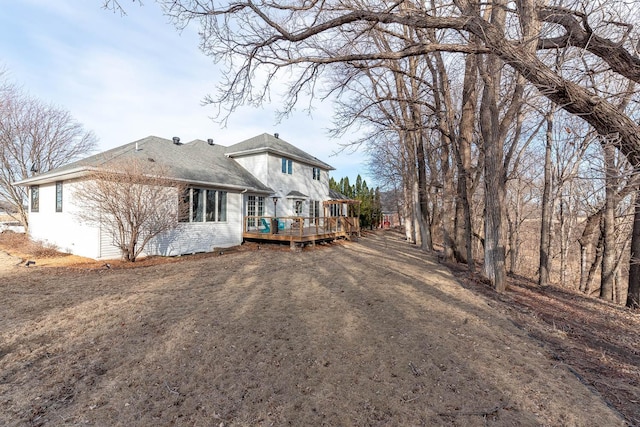 rear view of house featuring a deck