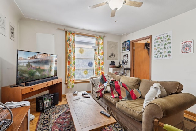 living room featuring hardwood / wood-style floors and ceiling fan