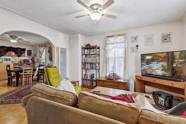 living room featuring hardwood / wood-style flooring and ceiling fan