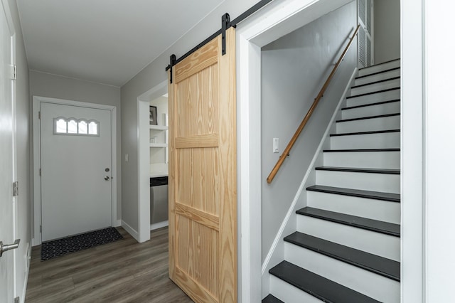 foyer entrance with hardwood / wood-style flooring and a barn door