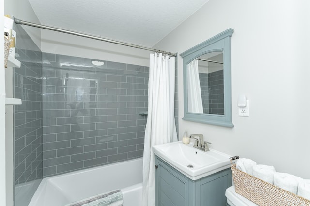 full bathroom featuring vanity, toilet, a textured ceiling, and shower / bath combo with shower curtain