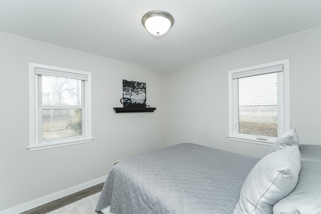 bedroom with dark hardwood / wood-style floors