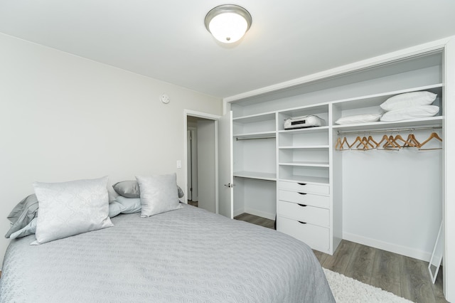 bedroom with dark hardwood / wood-style floors