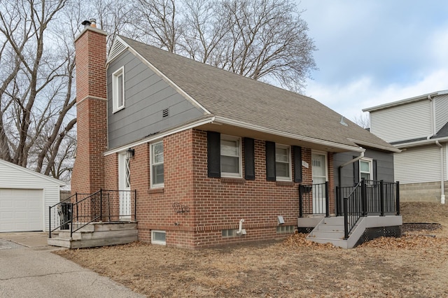 bungalow-style house with a garage and an outbuilding