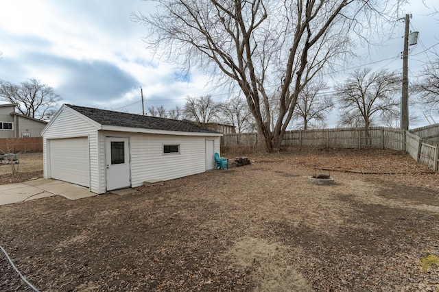 view of yard with a garage and an outbuilding