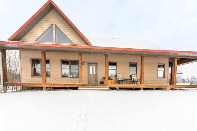 snow covered house with a porch