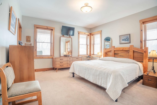 carpeted bedroom featuring multiple windows