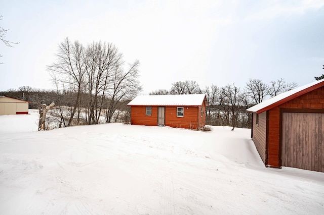 yard covered in snow featuring an outdoor structure