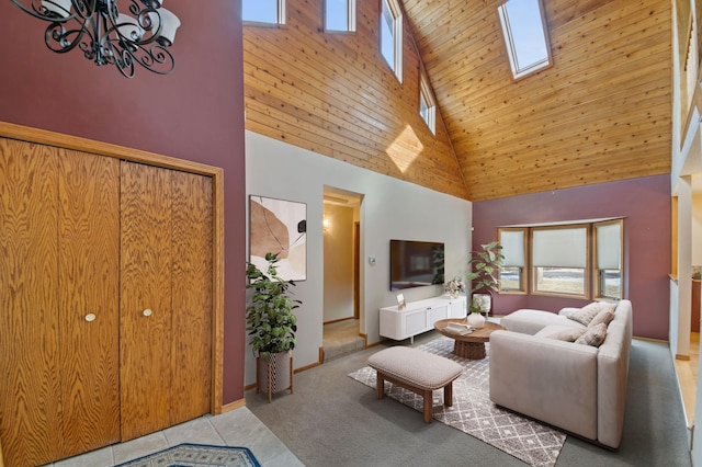 carpeted living room featuring a skylight, a high ceiling, and plenty of natural light