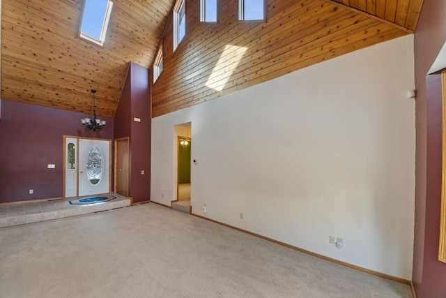 unfurnished living room with high vaulted ceiling, a skylight, a chandelier, wood ceiling, and light carpet