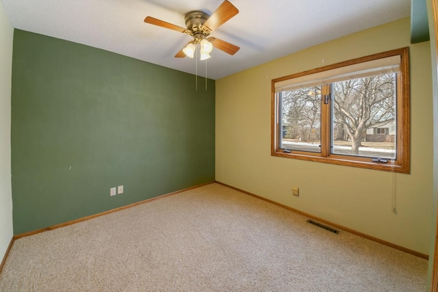 empty room with ceiling fan and carpet flooring