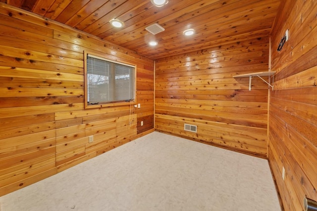 spare room with wood ceiling and wood walls