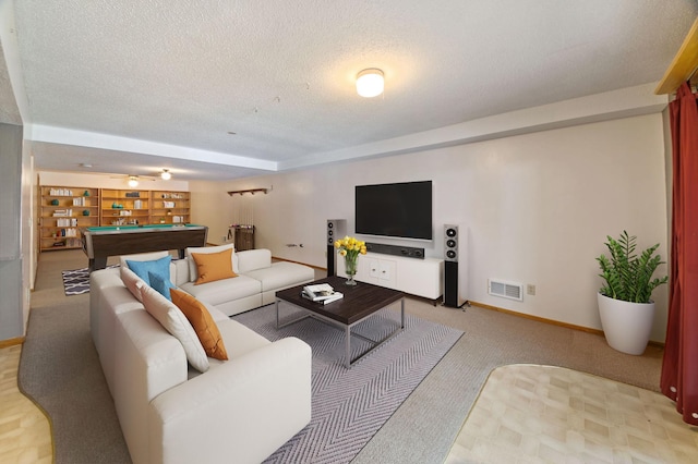 carpeted living room featuring pool table and a textured ceiling