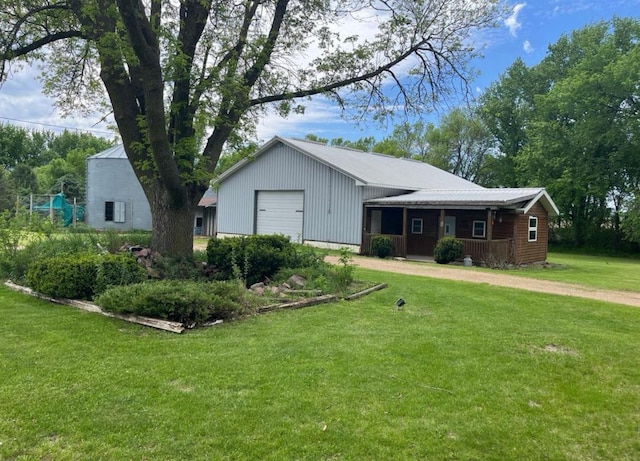 view of front of house with a porch, a garage, and a front yard