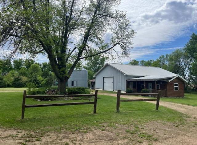 exterior space featuring an outbuilding, a garage, and a front yard