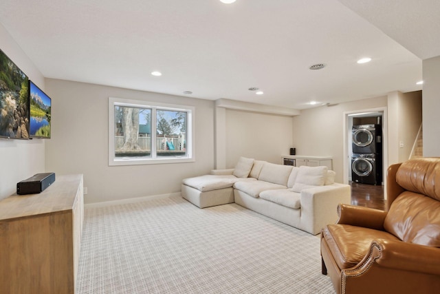 carpeted living room featuring stacked washer / dryer