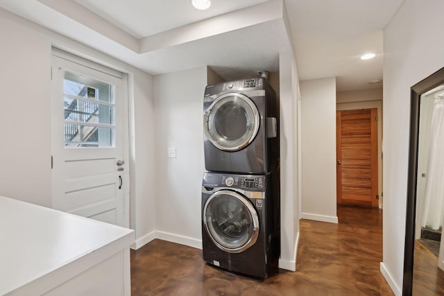 laundry area featuring stacked washer / drying machine