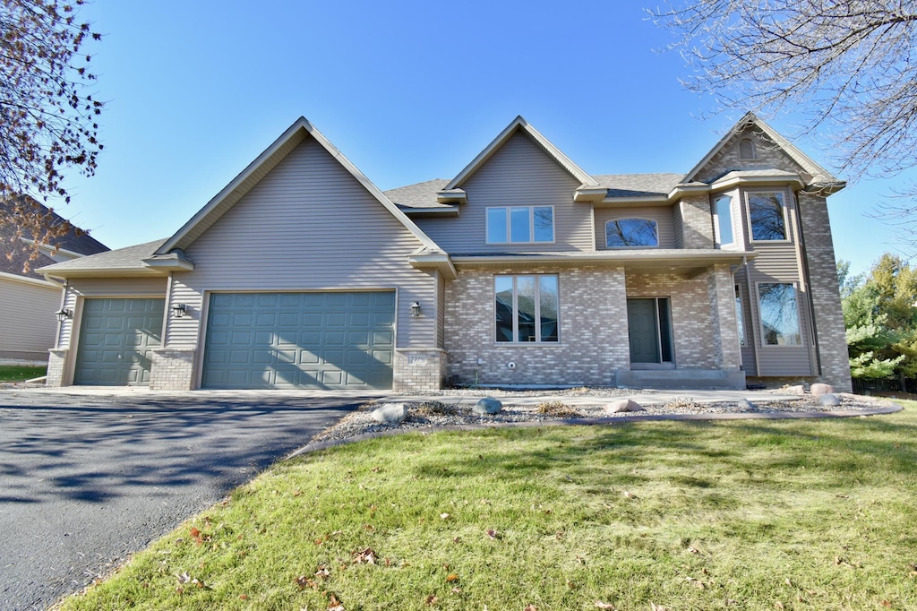 view of front facade featuring a garage and a front lawn