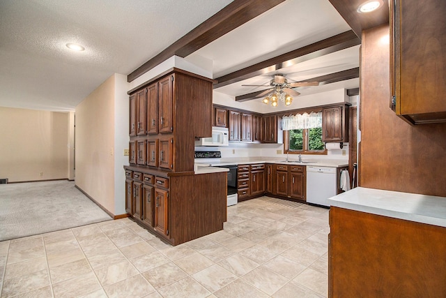 kitchen with sink, white appliances, a textured ceiling, beamed ceiling, and ceiling fan