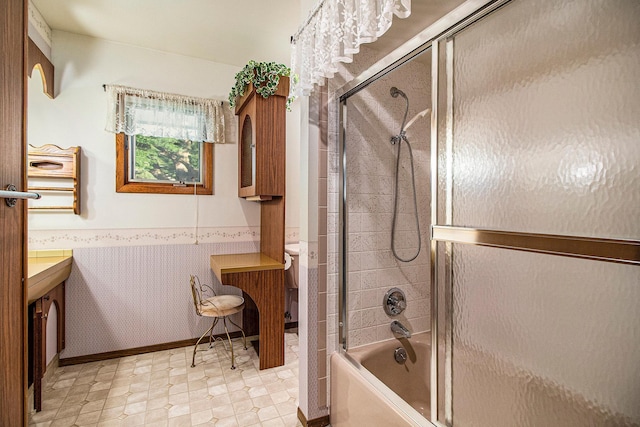 full bathroom with vanity, enclosed tub / shower combo, and toilet