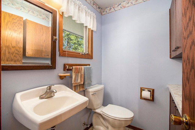 bathroom featuring toilet and sink