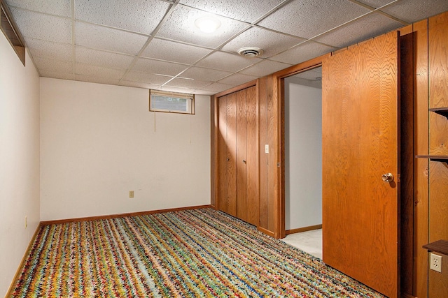 interior space featuring light colored carpet and a drop ceiling