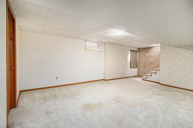 basement featuring carpet floors and a drop ceiling