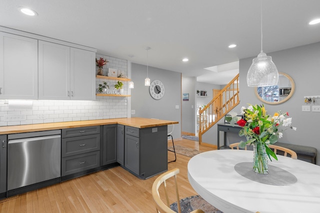 kitchen with hanging light fixtures, white cabinetry, dishwasher, and gray cabinetry