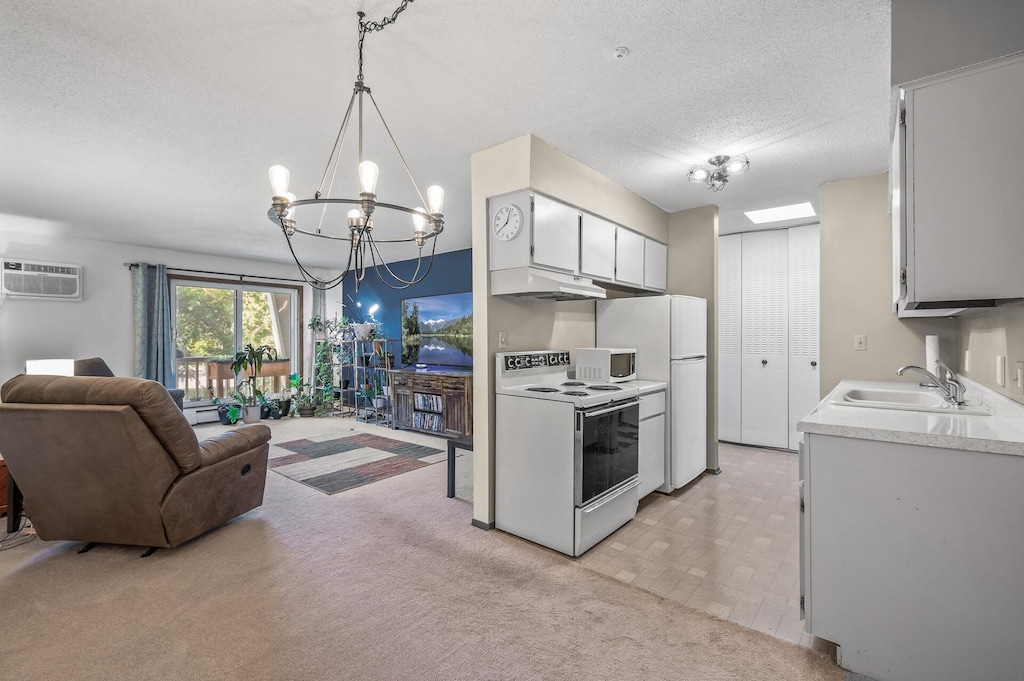 kitchen featuring sink, white cabinetry, decorative light fixtures, a textured ceiling, and white appliances