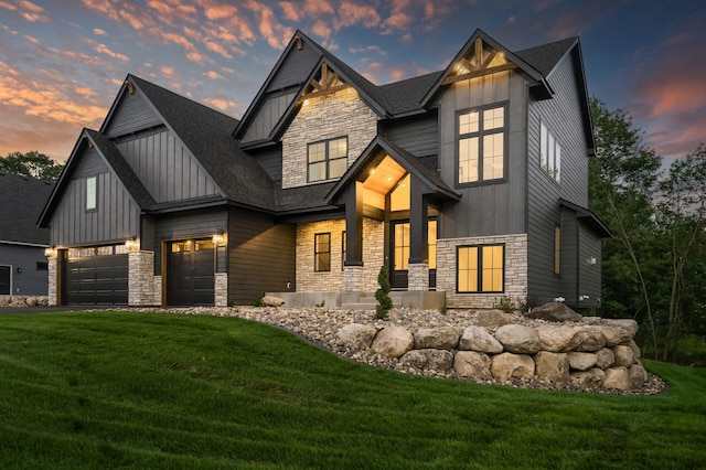 view of front of house featuring a yard and a garage