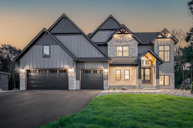 view of front facade with a garage and a lawn