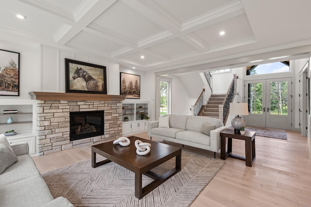 living room featuring beamed ceiling, plenty of natural light, and coffered ceiling