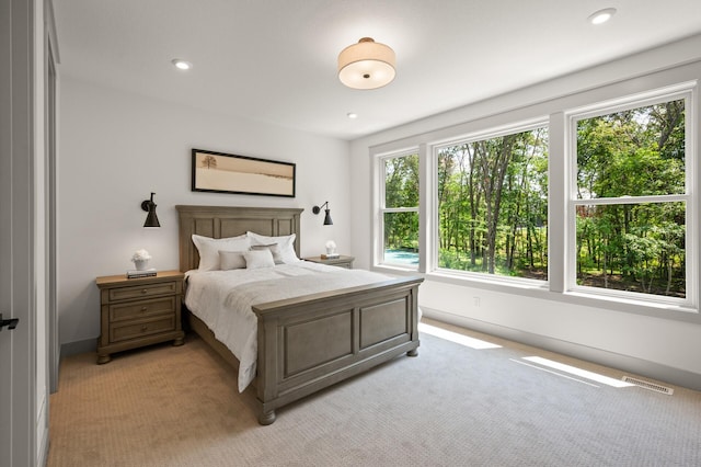 bedroom featuring light colored carpet