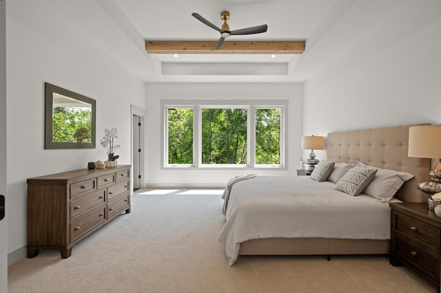 bedroom with light colored carpet and beam ceiling