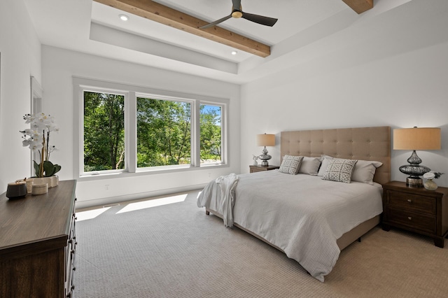 carpeted bedroom featuring ceiling fan and beamed ceiling