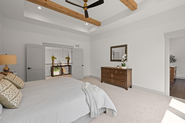 bedroom featuring ceiling fan, beam ceiling, carpet floors, and a high ceiling