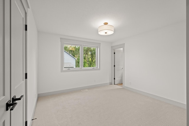 unfurnished bedroom with light carpet