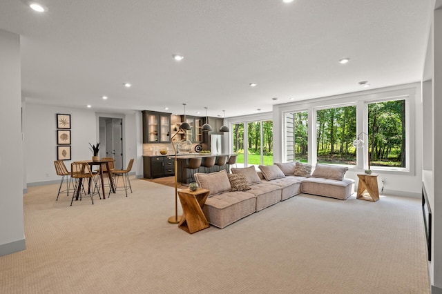 living room with sink and light colored carpet