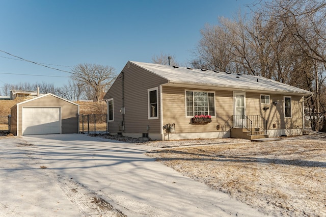 view of front of property featuring a garage and an outdoor structure