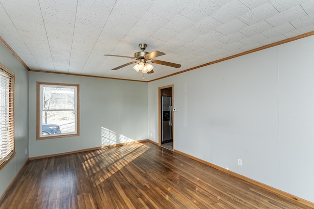 unfurnished room featuring dark wood-type flooring, crown molding, and ceiling fan