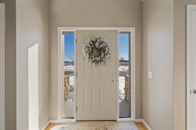 entrance foyer with light wood finished floors and baseboards