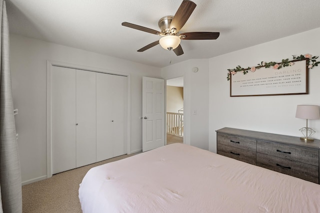 bedroom with carpet floors, a closet, and a ceiling fan