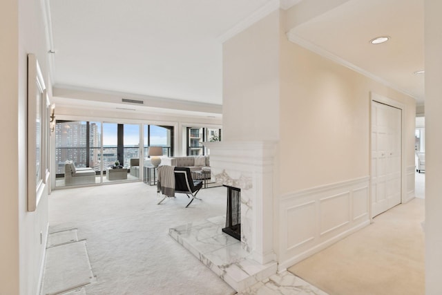 corridor featuring crown molding and light carpet