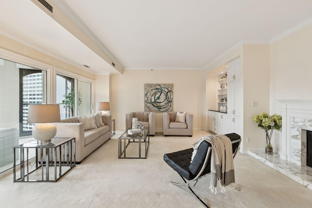 living room with light colored carpet, ornamental molding, a premium fireplace, and built in shelves