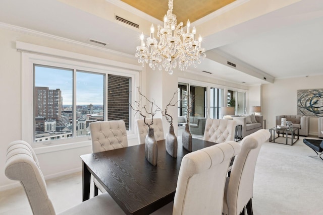 dining area with crown molding, a chandelier, and carpet flooring