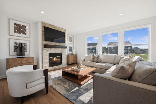 living room with hardwood / wood-style flooring and a fireplace