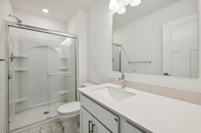 bathroom with vanity, an enclosed shower, and toilet