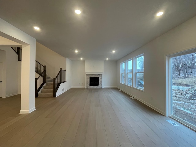 unfurnished living room with a fireplace and wood-type flooring