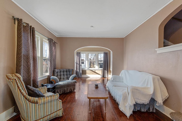 living area featuring hardwood / wood-style flooring and ornamental molding